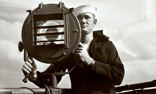 A signalman at his post during World War II convoy operations.