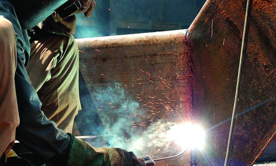 A welder working on a ship