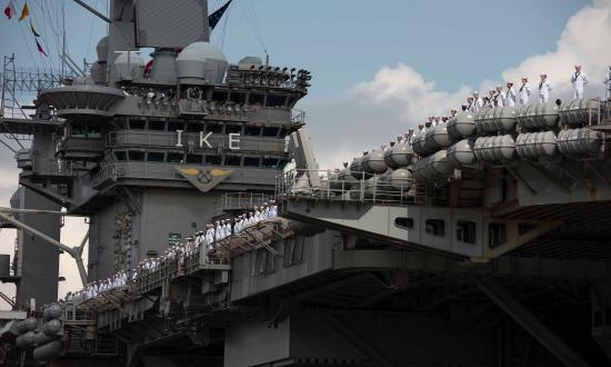 The crew of the USS Dwight D. Eisenhower (CVN-69) mans the rails as the carrier returns from a deployment in August.  