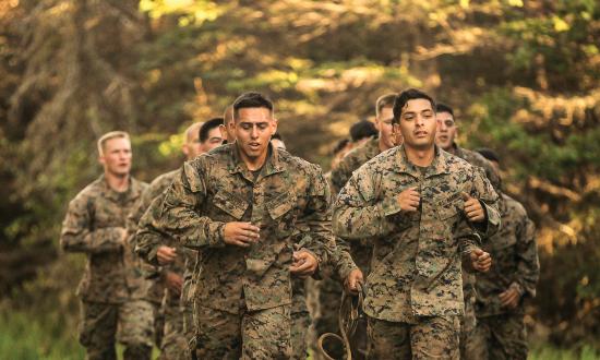 Marines running to the next event in an obstacle course 