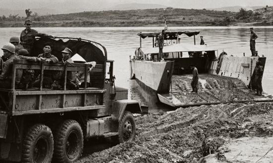 The LCM-860, known as the Liberty Ferry for her role in closing the overwater gap in the Danang to An Hoa overland supply route, prepares to transport Vietnamese soldiers across the Thu Bon River.