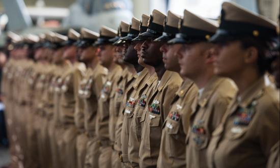 Fiscal Year 2017 chief petty officers stand at attention during a chief pinning ceremony aboard the aircraft carrier USS George H.W. Bush (CVN-77)