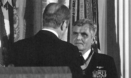 President of the United States of America, Gerald R. Ford, (back to camera) presents the Congressional Medal of Honor to Rear Admiral James B. Stockdale, USN, during an awards ceremony in the East Room of the White House