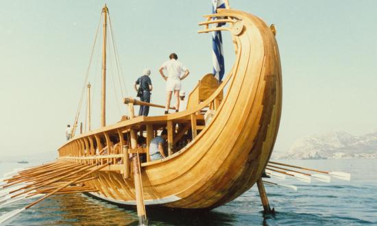 A stern view of the Hellenic Navy’s historic recreation of a trireme, named the HS Olympias, at ease with oars up in 1987. Much like carriers, galleys once were seen as the ultimate design for delivering naval power. 