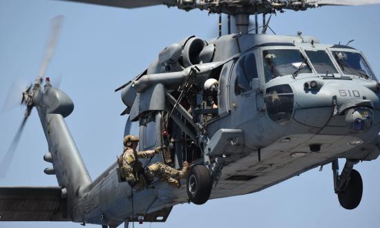  Lt. Braden Schrock prepares to fast-rope from an MH-60S Seahawk helicopter, assigned to the "Dragon Slayers" of Helicopter Sea Combat Squadron (HSC) 11, on to the flight deck aboard the Nimitz-class aircraft carrier USS Harry S. Truman (CVN-75)