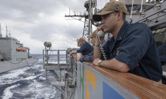 Ensign Morgen Richards stands communication watch on the bridge wing of the guided-missile cruiser USS Antietam (CG-54) during a replenishment-at-sea evolution.