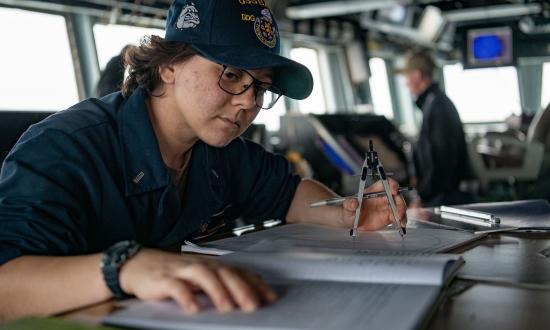 On board the guided-missile destroyer USS Barry (DDG-52), Lieutenant (junior grade) Hannah Lee plots using a maneuvering board during a Taiwan Strait transit.
