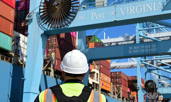 A Coast Guard member conducts shipping container inspection training at the Port of Virginia in 2022. The Coast Guard must develop strategic plans of action to shore up cybersecurity norms and best practices for the MTS. 