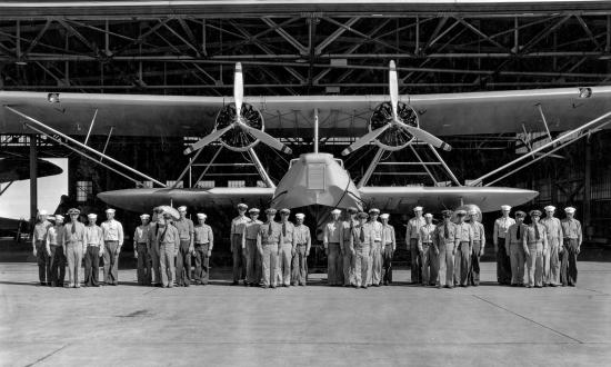 Personnel of VP-10F making one stop flight from Coco Solo to San Diego, grouped according to their plane crews in front of a U.S. Navy P2Y-1 aircraft
