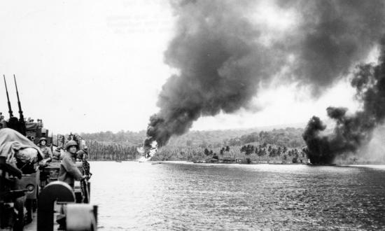 Gun crews aboard ship stand by at their posts as Japanese bombers provided this sobering welcome for a U.S. warship sailing into port at Guadalcana