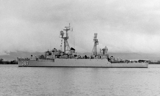 Port broadside view of the USS Vance (DER-387) entering Pearl Harbor post 1955.