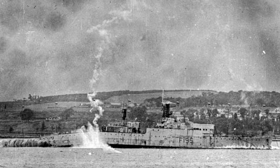 Ex-HMS Roebuck photographed at the instant of maximum "jack-knifing" from an underwater explosion during tests conducted by U.S./U.K. teams.