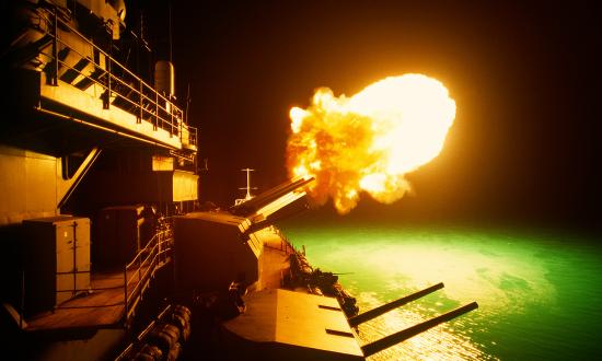 A Mark 7 16-inch/50 caliber gun is fired aboard the battleship USS MISSOURI (BB-63) as night shelling of Iraqi targets takes place along the northern Kuwaiti coast during Operation Desert Storm.