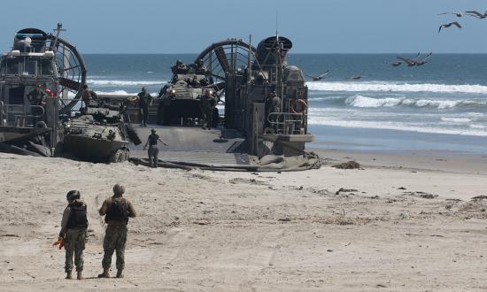 U.S. Marines offload light armored vehicles from an air-cushion landing craft as part of a mobile reconnaissance battalion exercise in May 2024. Current surface connectors were designed for ship-to-shore assault rather than sustained littoral combat and fall short in mobility, firepower, and survivability.