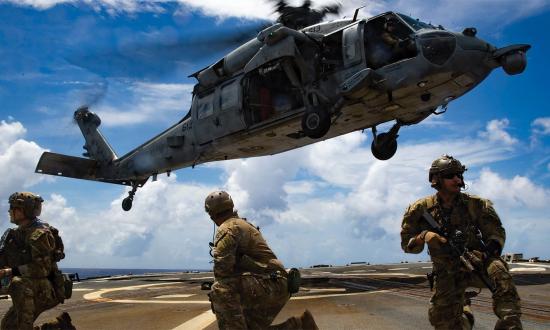 Sailors from Explosive Ordnance Disposal Mobile Unit 3 practice helicopter visit, board, search, and seizure activities. During war, enemy-flagged civilian ships and contraband-carrying neutral vessels—as distinguished from enemy warships or neutral ships engaged in hostilities—can lawfully be seized and disposed of through a formal legal process under prize law.