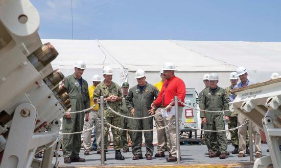 Adm. Robert P. Burke, Vice Chief of Naval Operations, second from left, receives a brief on USS Gerald R. Ford’s (CVN 78) advanced weapons elevators