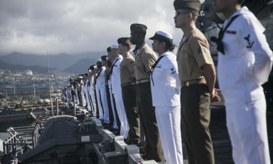 Sailors and Marines man the rails of the USS Essex (LHD-2) in Pearl Harbor, Hawaii.