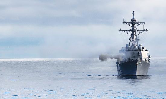 The USS Pinckney (DDG-91) fires her forward gun.