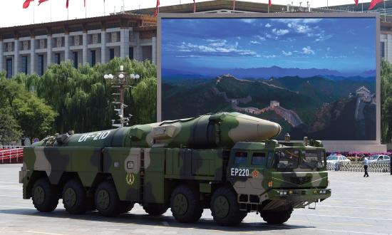 A military vehicle carries DF-21D missile past a display screen featuring an image of the Great Wall of China at Tiananmen Square in Beijing on September 3, 2015