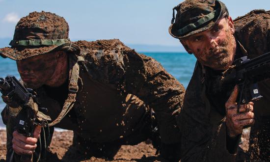 U.S. Marines assigned to a reconnaissance detachment prepare to move on an objective as part of amphibious operations training during an exercise in Lido Beach, Greece.