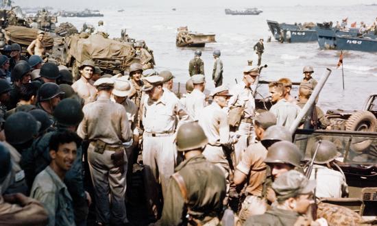 “I have returned.” General Douglas MacArthur (left center, hands on hips) inspects the beachhead on Leyte Island, 20 October 1944.