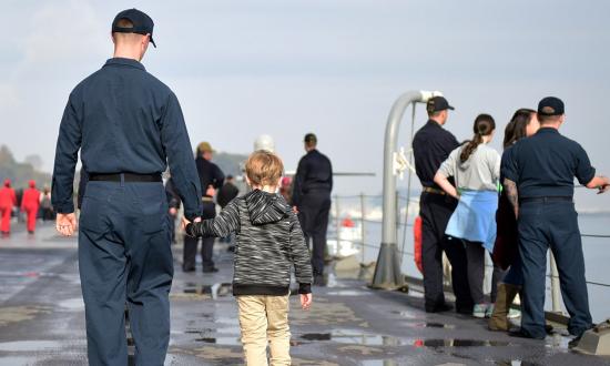 Hospital Corpsman 1st Class Nicholas Belflower, attached to U.S. 7th Fleet Flagship USS Blue Ridge (LCC 19), walks the main deck with his son during the ship's first Family Day Cruise in December 2018