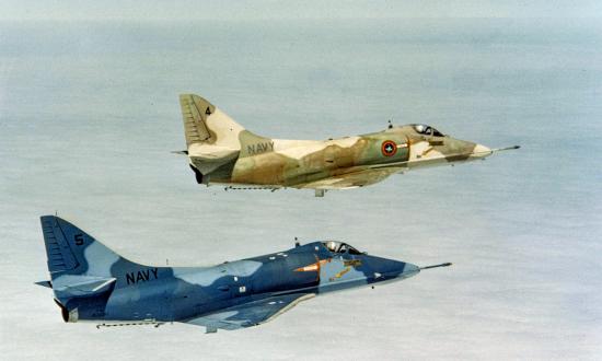 Two A-4E aggressor aircraft in flight.