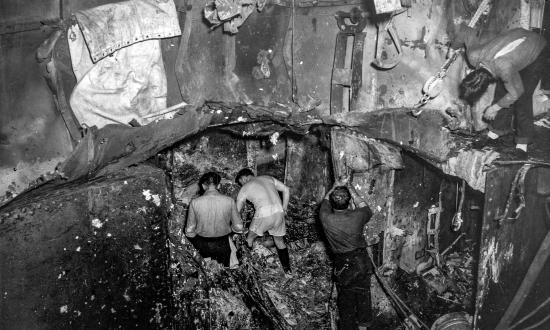 A repair party works in a hole made by a blast on the Yorktown's third deck.