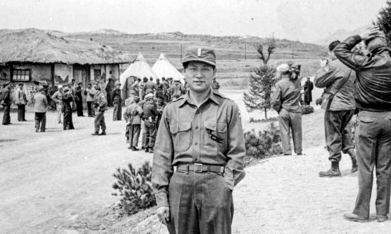 John K. C. Oh standing outside in Korea in 1953