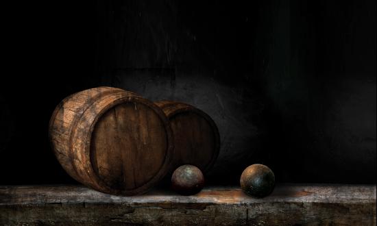 Stock photo of two cannon balls laying near a cask